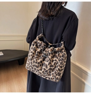 Detail of leopard print plush tote bag with drawstring closure and polka dot rope handle