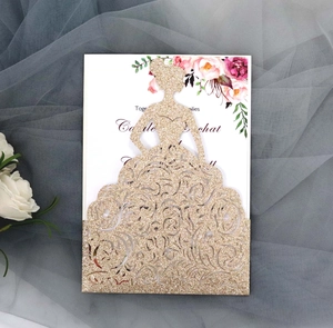 Detail of laser-cut gold glitter wedding invitation with bride silhouette and floral insert