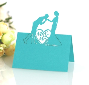 Detail of laser-cut heart Mr & Mrs wedding place card in elegant tiffany blue cardstock
