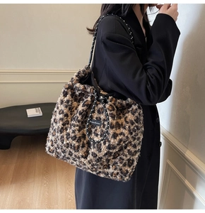 Detail of leopard print faux fur tote bag featuring durable polka dot rope handles