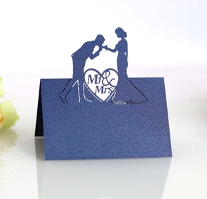 Detail of laser-cut Mr & Mrs navy blue glitter place card for wedding table decor
