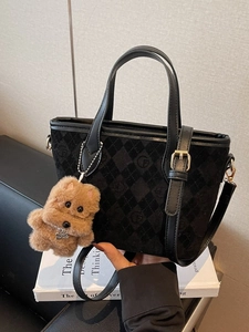 Quilted black suede tote bag with logo pattern, long strap and plush bear charm decoration