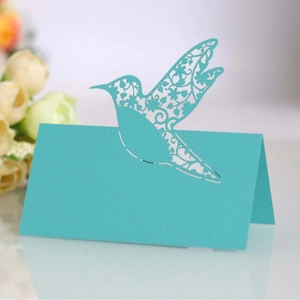 Elegant laser-cut hummingbird place card in tiffany blue for wedding table setting