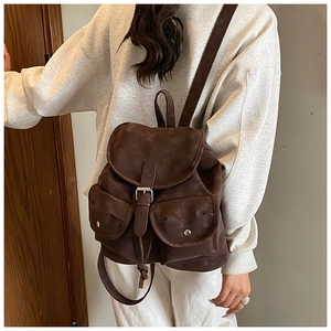 Side view of vintage large-capacity dark brown backpack with metal buckle closure