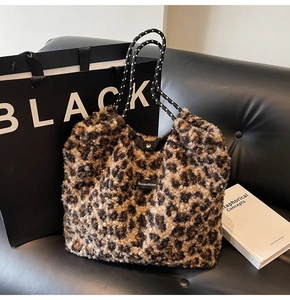 Detail of leopard print plush tote bag with Moonshine logo and woven handles
