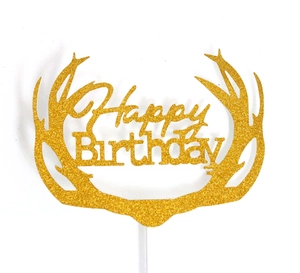 Close-up of golden glitter Happy Birthday cake topper with reindeer antler design