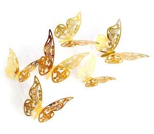 Detail of 3D gold butterfly wall stickers featuring intricate laser-cut floral patterns