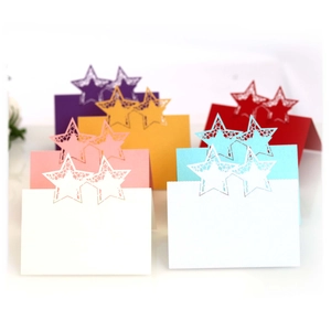 Laser-cut star hollow place cards in assorted pearlescent colors for wedding tables