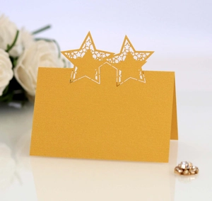 Golden laser-cut star place card for weddings with elegant hollow geometric patterns