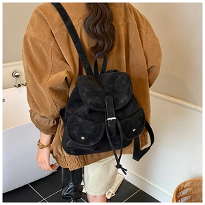 Close-up of vintage black travel backpack with metal buckle and drawstring closure