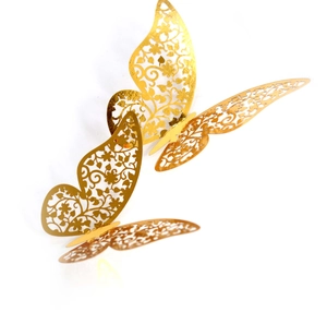 Detail of 3D gold hollow butterfly wall stickers with intricate floral laser-cut patterns