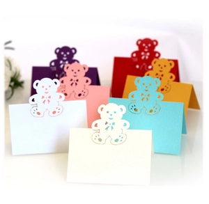 Laser-cut teddy bear hollow place cards in various colors for wedding table settings