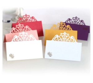 Laser-cut crown wedding place cards in multiple colors with elegant lace patterns