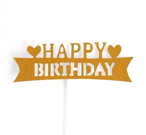 Detailed close-up of golden glitter Happy Birthday cake topper with laser-cut heart accents