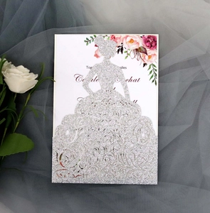 Detail of silver glitter laser cut wedding invitation featuring a bride silhouette