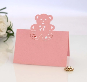 Pink laser-cut table card featuring hollow bear design for wedding party decoration