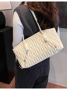Chic white pleated shoulder bag with quilted texture and knot strap for women