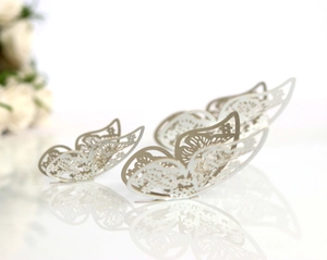 Macro shot of pearl white 3D butterfly wall stickers with intricate laser-cut hollow details