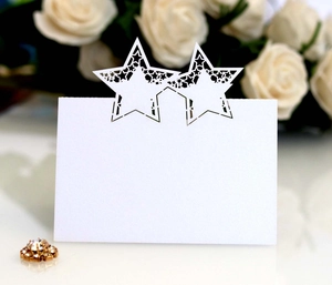 Elegant white laser-cut star place card for weddings with hollow star pattern and pearlescent finish