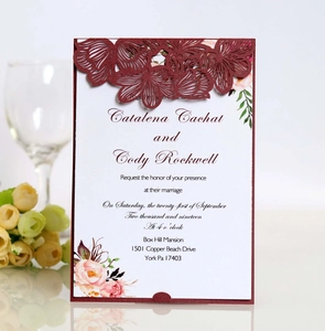 Laser-cut burgundy wedding invitation set with floral patterns and watercolor inserts