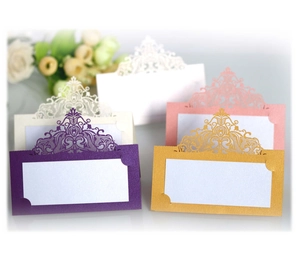 Detailed laser cut crown lace table cards in champagne gold, purple, and rose pink