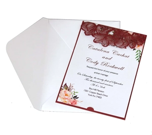 Laser-cut burgundy wedding invitation set with floral inner card and white envelope