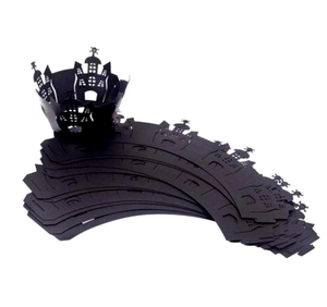 Macro detail of laser-cut black Halloween cupcake wrappers with castle and spire designs