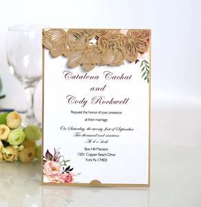 Detail showing laser cut floral wedding invitation with golden hollow out cover and inner card