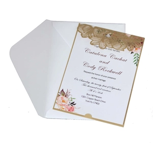 Detail of laser-cut rose pattern on ivory wedding invitation with floral printing