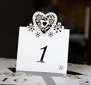 Detailed laser-cut heart pattern on elegant white wedding table number cards with number one