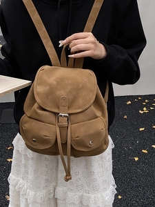 Vintage caramel brown suede travel backpack with flap closure and silver buckle detail