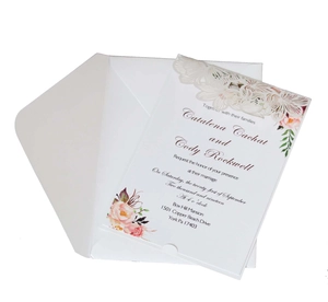 Detail showing the laser-cut hollow floral design on a vertical wedding invitation card