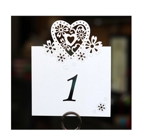 Detailed laser cut heart design on white wedding table number card with black number one
