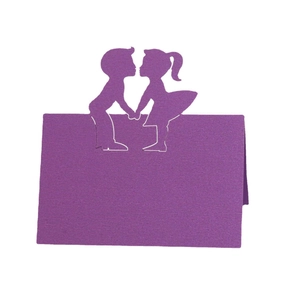 Purple laser-cut place cards with romantic boy and girl silhouette for wedding tables