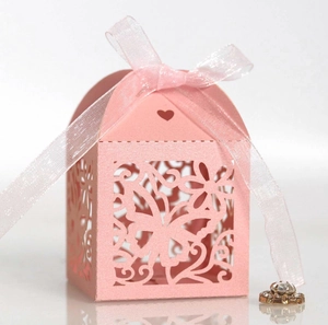 Pink laser-cut butterfly wedding favor box with ribbon bow and floral hollow patterns