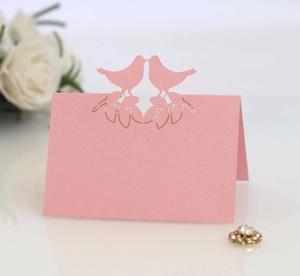 Pink laser cut place cards with romantic kissing birds design for wedding table decor
