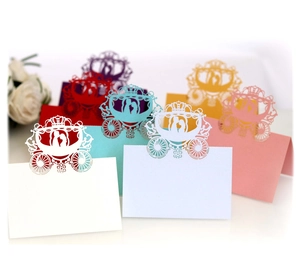 Laser-cut pumpkin carriage wedding place cards in various pearlescent paper colors