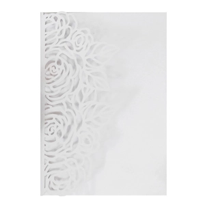 Close-up of white laser-cut wedding invitation featuring intricate rose and leaf patterns