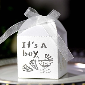 Close-up of laser-cut 'It's A boy' gift box with white ribbon for baby shower