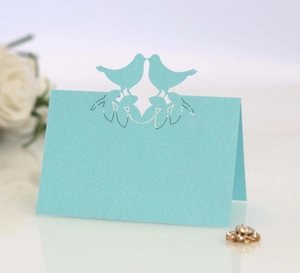 Elegant laser-cut light blue bird place cards for wedding table seating and decor