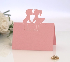 Laser cut pink wedding place card featuring a romantic boy and girl silhouette