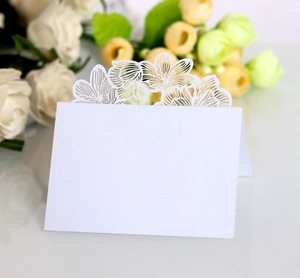 Detail of white laser-cut rose hollow place card with elegant pearl luster finish