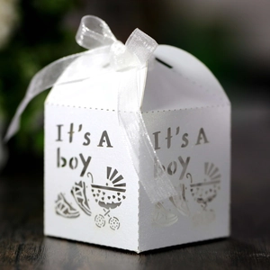 Detail of laser-cut 'It's A boy' gift box with baby stroller patterns and white silk bow