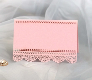 Elegant pink laser-cut lace place cards for wedding tables with pearlescent paper finish