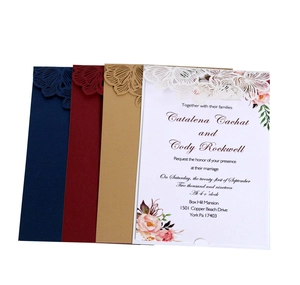 Laser-cut wedding invitations in navy, burgundy, and gold with intricate floral patterns
