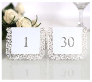 Elegant white laser-cut wedding table cards with lace rose border and numbers 1 to 30