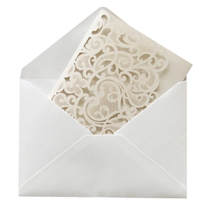 Detail of laser-cut burgundy invitation with floral heart patterns and white envelope