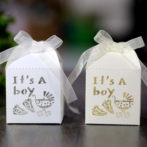 Detail of laser-cut 'It's A boy' gift boxes with stroller patterns and silk ribbons