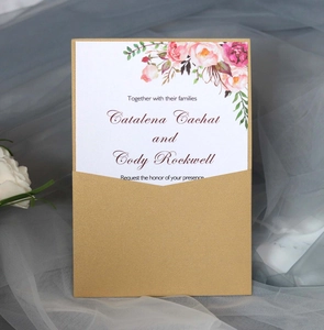 Elegant laser-cut gold wedding invitation with watercolor floral design on soft mesh background