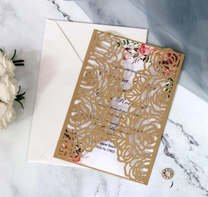 Detail of laser-cut rose floral wedding invitation with elegant inner card and envelope